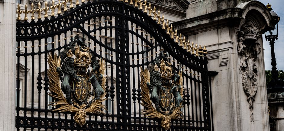 A painted metal gate with a latch and hinge