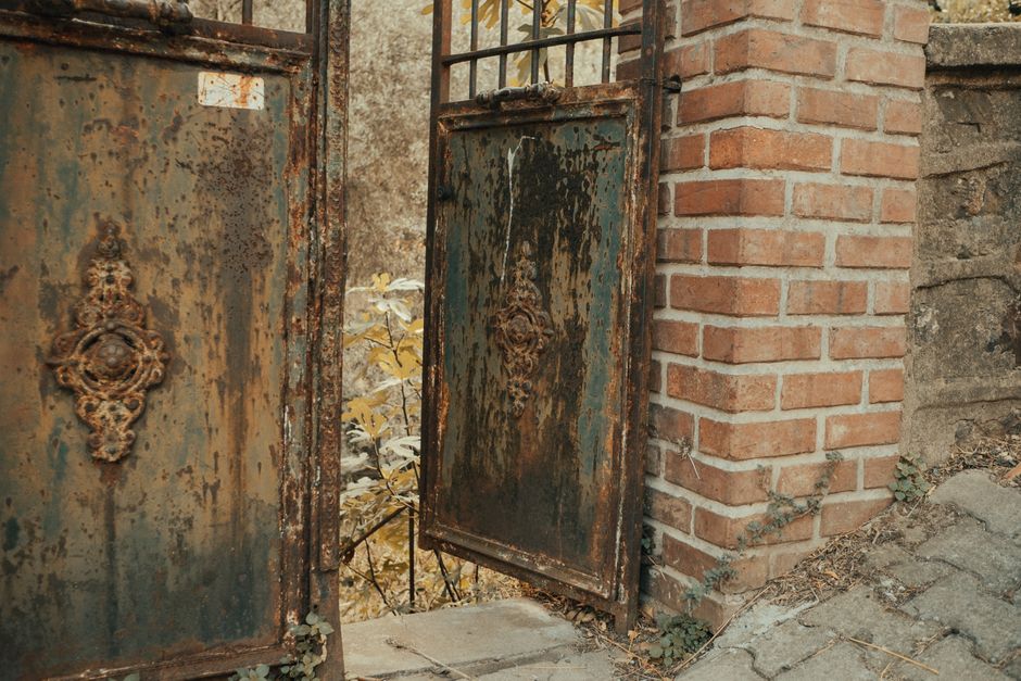 An iron gate with ornamental detail