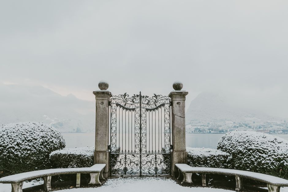 A painted metal gate with a latch and hinge
