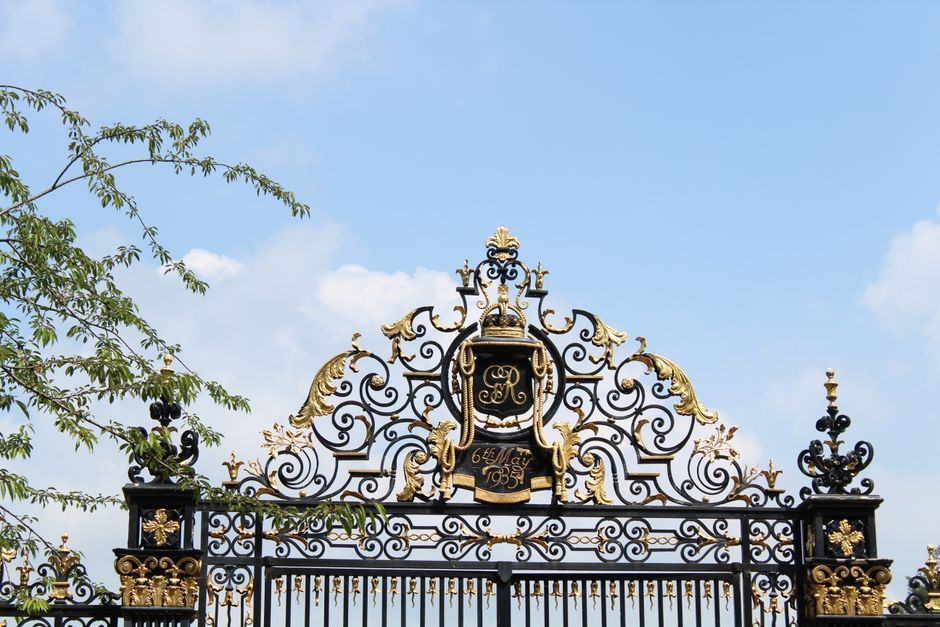 A metal gate and fence section photographed up close